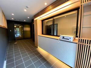 a kitchen with a window and a microwave on a counter at HIZ HOTEL Gion-Shirakawa in Kyoto