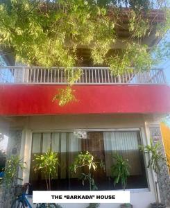 a red and white building with a balcony at Perlies Inn NEW Barkada House with NETFLIX and WIFI in Tanay