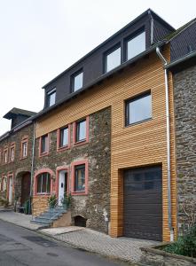 a large brick building with a garage at Ferienhaus Wehlener Rosengarten in Bernkastel-Kues