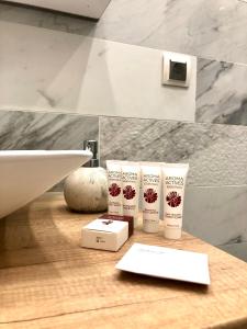 a bathroom with three products on a counter next to a sink at Strada Ion I. C. Brătianu Nr.24 in Cluj-Napoca