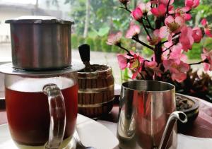 a coffee maker and a cup of coffee on a table at Bakom Inn Syariah in Bogor