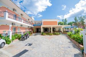 a courtyard of a building with motorcycles parked in it at Maltezos Hotel in Gouvia