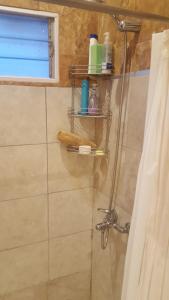 a bathroom with a shower with a shower curtain at Mirador del Valle in Valle Hermoso