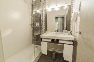 a white bathroom with a sink and a shower at Best Western Plus Evreux Palais Des Congrès in Évreux