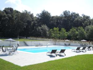 a pool with a bunch of chairs and a group at Miglio d'Oro Park Hotel in Ercolano