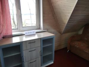 a room with a desk and two windows and a chair at Гостевой двор хутор Скреблово in Skreblovo