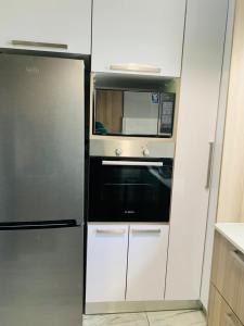 a kitchen with a microwave and a refrigerator at Musgrave Seafern in Durban