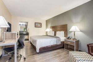 a hotel room with a bed and a desk at Econo Lodge North Charleston in Charleston