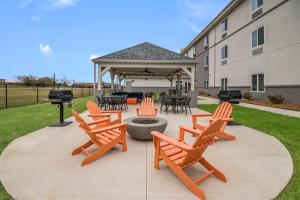 a patio with chairs and a fire pit in front of a building at MainStay Suites in Union City