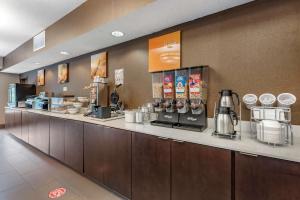 a restaurant with a counter with a coffee station at Comfort Suites Auburn near I-69 in Auburn