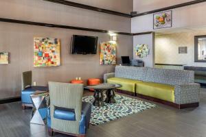 a waiting room with chairs and a table and a tv at Comfort Inn & Suites Pauls Valley - City Lake in Pauls Valley