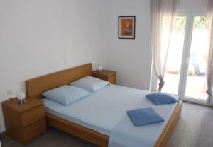 Postel nebo postele na pokoji v ubytování Filipovic Apartmani