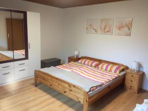 a bedroom with a bed and a mirror at Haus Bergblick in Luftkurort Lückendorf