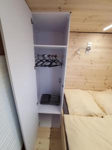 a small room with two beds and a closet at Hausboot Geiselruh in Braunsbedra