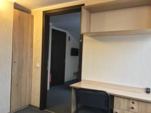 a room with a desk and a door to a hallway at Guest House SOTNI in Kyiv