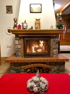 - une cheminée dans le salon orné d'ornements de Noël dans l'établissement Rojaus Slenis, à Druskininkai