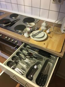 a drawer filled with utensils on top of a stove at Monteurwohnung in Rommerskirchen in Rommerskirchen