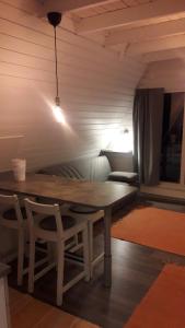 a table and chairs in a room with a couch at Karemajat superb cottage in Ylitornio +20 photos