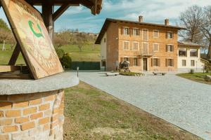 a large brick building with a stone walkway in front of it at 'L Piasi in Cortanze