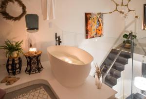 a bathroom with a large white tub on a counter at Hedo & Art Loft - Old Town in Poznań