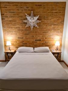 a bedroom with a bed with a snowflake on the wall at Pousada Nossa Senhora Aparecida in Águas de São Pedro