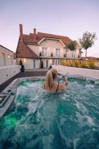 a woman in a swimming pool in a house at Dozsa Residence in Oradea