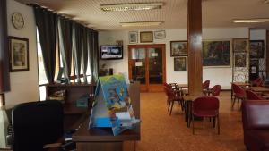 a dining room with a table and chairs and a room with tables at Hotel Miami in Tossa de Mar