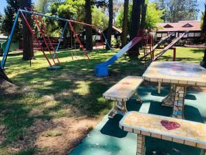 a park with a playground with benches and swings at Hotel Villa Santa Maiani in Mar del Plata