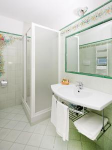 bagno bianco con lavandino e doccia di Hotel Le Terrazze a Conca dei Marini