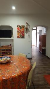 a dining room with a table with a bowl on it at Appartamento " CENTRAL" in Arzachena