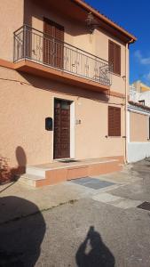 a shadow of a person standing in front of a building at Appartamento " CENTRAL" in Arzachena