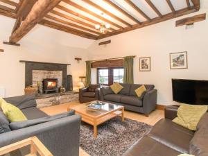 a living room with couches and a fireplace at Riven Oak in Kendal