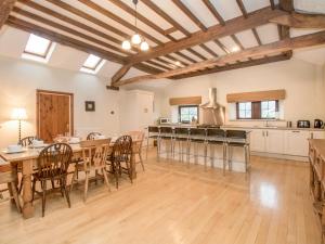 a large kitchen and dining room with a table and chairs at Riven Oak in Kendal