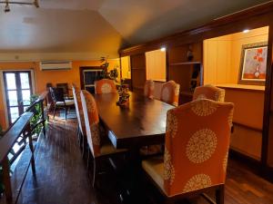a dining room with a wooden table and chairs at The Landmark St Thomas in Fort Christian