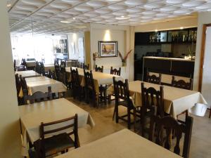 a dining room with tables and chairs in a restaurant at Gran Hotel España in La Falda