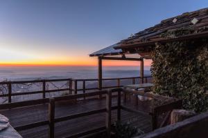 a wooden deck with a sunset in the background at Chalet Palù in Brosso