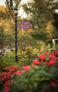 a street sign on a light pole in a garden at Azalea Inn and Villas in Savannah