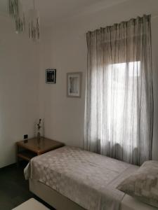 a bedroom with a bed and a window at Apartmani Nika in Rijeka