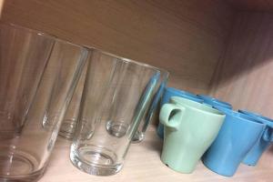 four glass vases and a cup on a table at Studio in Stretford with Great Transport Links in Manchester