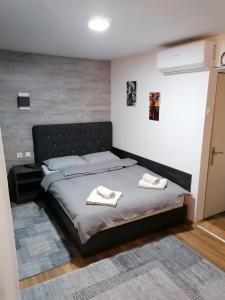 a bedroom with a bed with two towels on it at Prenoćište Day Holiday in Smederevo