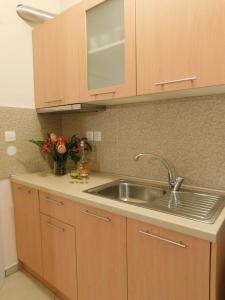 a kitchen with a sink and a vase of flowers at Anna house 3 in Sarti