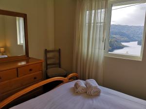 1 dormitorio con 1 cama con tocador y ventana en Casa de Bouças, en São Pedro