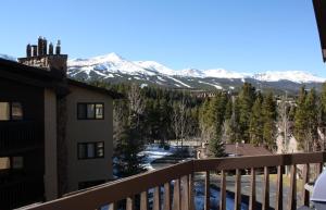a view of snow covered mountains from a balcony at Woods Manor #302-A - Close to Main Street - Access to Indoor Hot Tub and Shuttle in Breckenridge