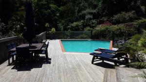 a patio with a table and chairs next to a pool at Bluff Hill Bed & Breakfast in Napier