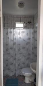 a bathroom with a shower curtain and a toilet at Pousada São Francisco in Morretes +27 photos