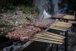 a grill with several skewers of meat on it at BEST HOUSE CAMPO DI GIOVE in Campo di Giove