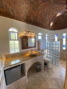 a bathroom with a sink and a mirror and a toilet at Ventana Bay Resort in La Ventana