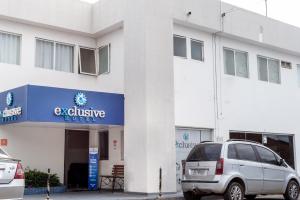 a building with a car parked in front of it at Exclusive Hotel in Petrolina