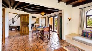 a living room filled with furniture and a large window at Villa Santa Cruz in Todos Santos