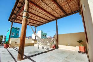 a hammock on the roof of a house at Hotel Casa Sarah in Santa Marta